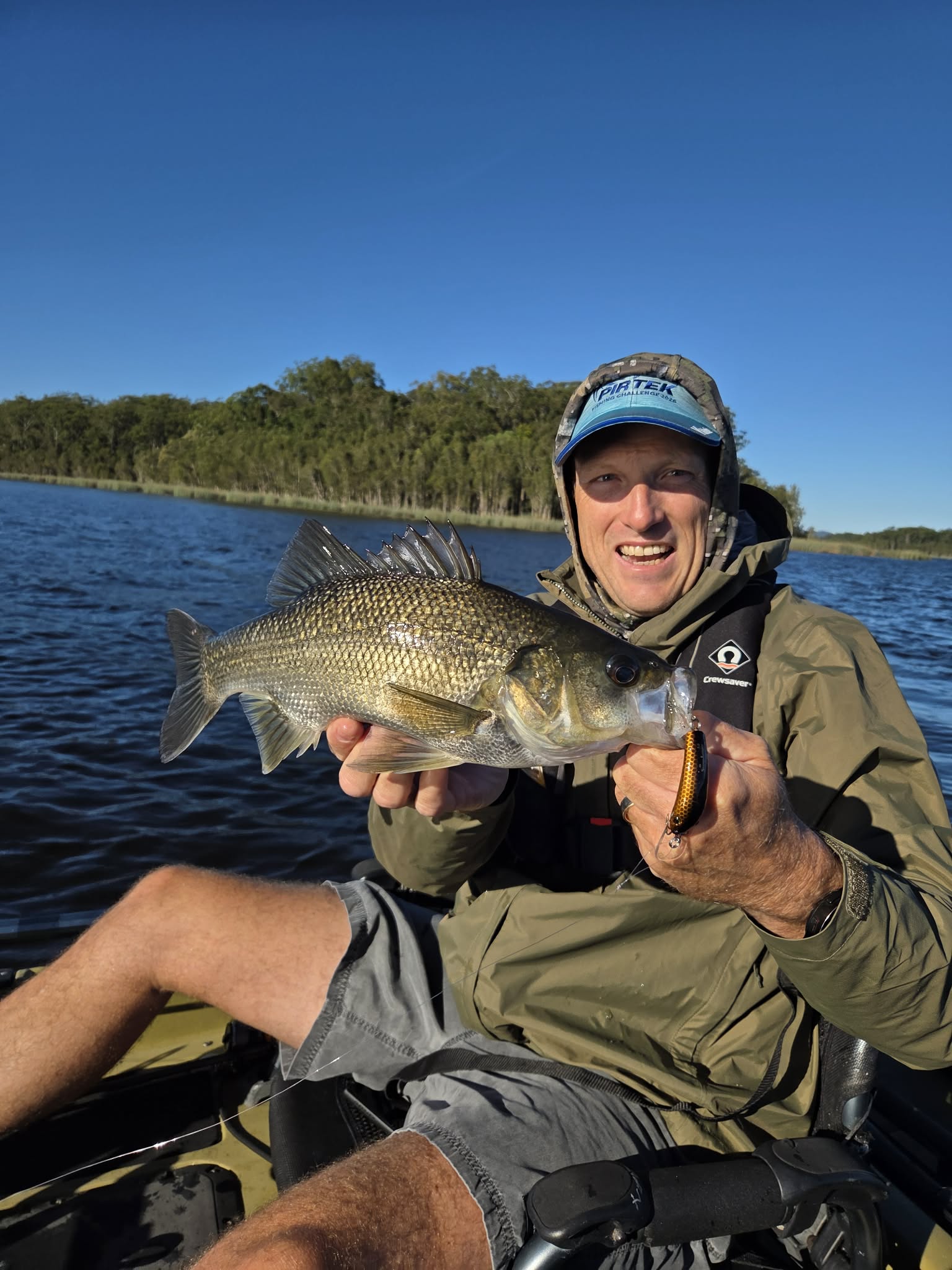 Rodney holding an Australian bass on a kayak
